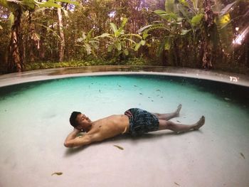 Low section of man relaxing in water