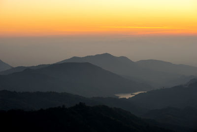 Scenic view of silhouette mountains against sky during sunset
