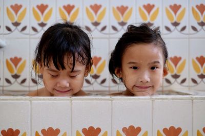 Siblings bathing in tub at home 