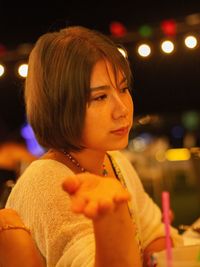 Portrait of young woman at night