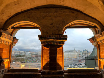 Buildings in city against cloudy sky