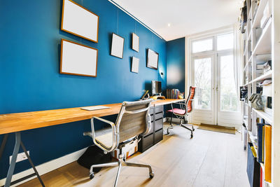 Empty chairs and tables against wall at home