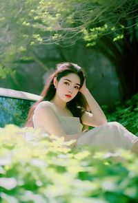 Portrait of young woman sitting on hammock