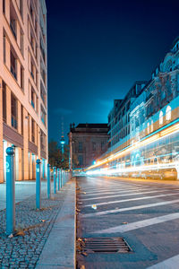 Illuminated city street and buildings at night