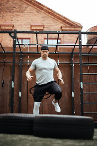 Mature man exercising in backyard