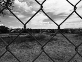 Close-up of chainlink fence against sky