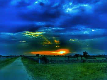 Scenic view of field against sky at sunset