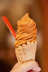 Close-up of hand holding ice cream cone