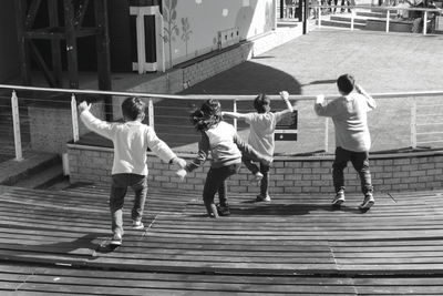 Rear view of people walking on staircase