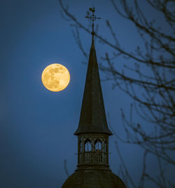 Low angle view of tower against sky at night