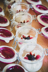 High angle view of dessert in jars on table 