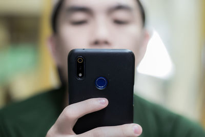 Close-up of man using mobile phone