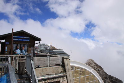 People at observation point against sky