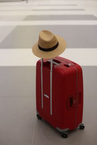 Close-up of red hat on floor against wall