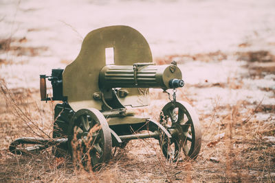 Close-up of old machinery on field