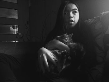 Portrait of young woman sitting at home