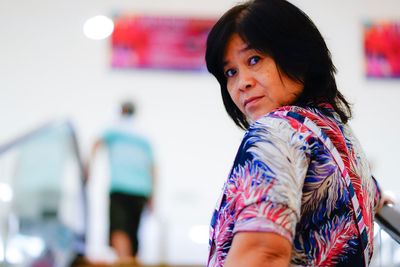 Portrait of woman standing in shopping mall