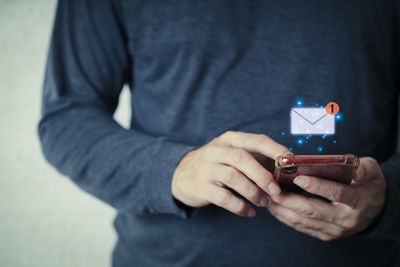 Midsection of man using mobile phone