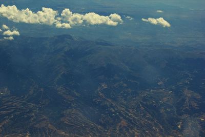 High angle view of land and mountains against sky