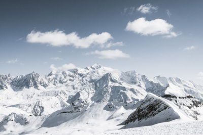 Scenic view of snow covered mountains against sky