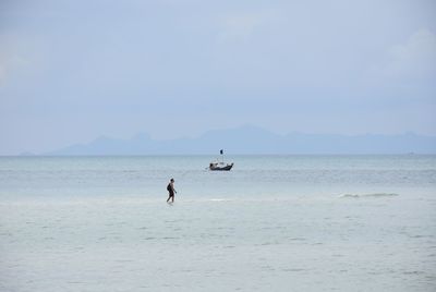 People on beach against sky