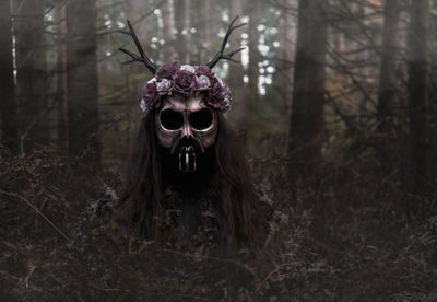 Close-up of spooky halloween decorations on plants in forest