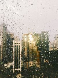 Buildings seen through wet window in rainy season
