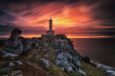 Statue of lighthouse at sunset