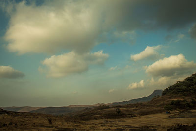 Scenic view of landscape against cloudy sky