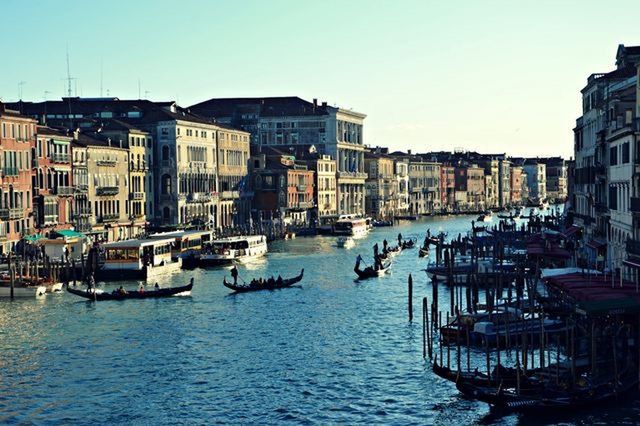 nautical vessel, building exterior, water, architecture, built structure, boat, transportation, moored, mode of transport, waterfront, canal, city, clear sky, harbor, sea, sky, river, residential structure, travel, residential building