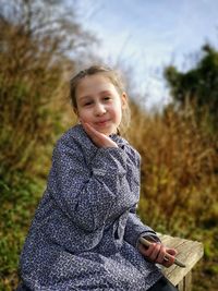 Portrait of smiling girl standing on land