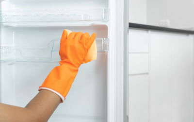 Close-up of woman holding hands at home