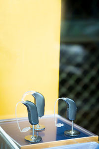 Close-up of electric lamp on table against wall