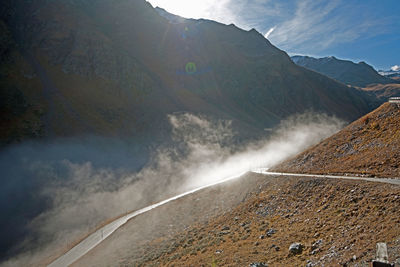 Scenic view of mountains against cloudy sky