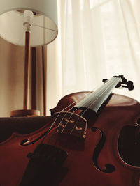 Close-up of guitar on table at home