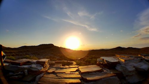 Scenic view of mountains seen from cliff at sunset