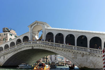 View of arch bridge against blue sky