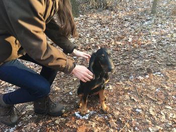 Low section of woman with dog