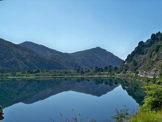 mountain, mountain range, tranquil scene, tranquility, scenics, water, lake, clear sky, beauty in nature, reflection, blue, nature, tree, copy space, idyllic, landscape, river, non-urban scene, standing water, calm