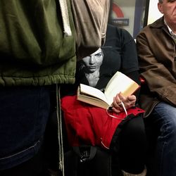 Rear view of men sitting on book