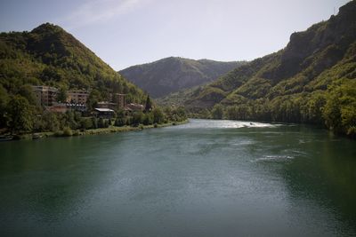Scenic view of lake and mountains against sky