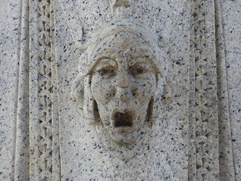 Close-up of cross sculpture against wall