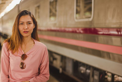 Portrait of woman at railroad station platform