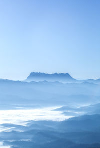 Scenic view of mountains against blue sky