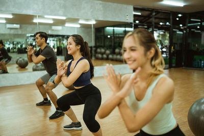 Friends exercising in gym