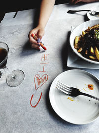 Cropped hand of person preparing food on table