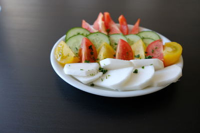 Close-up of fruits in plate on table