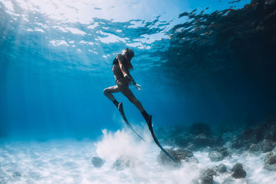 Low angle view of man swimming in sea