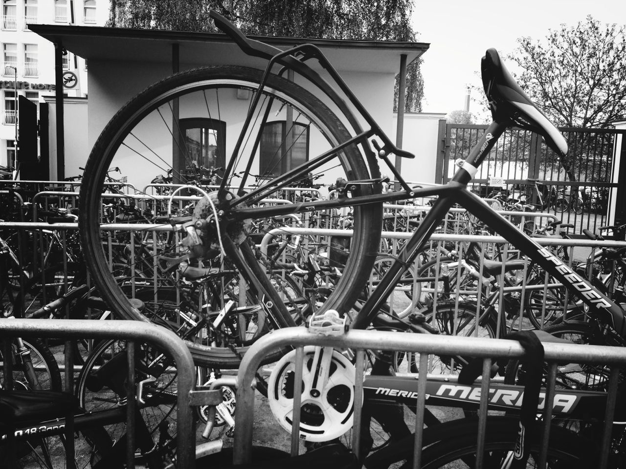 bicycle, transportation, mode of transport, land vehicle, metal, wheel, stationary, metallic, day, built structure, part of, parked, outdoors, parking, no people, railing, close-up, architecture, travel, cropped