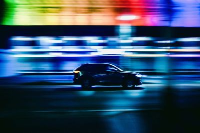 Traffic on city street at night. panning shoot car photography. rainbow light at night.